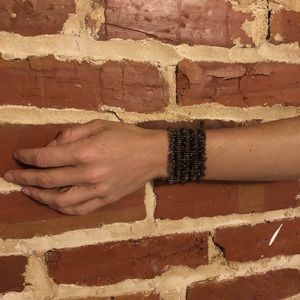 Handmade purple cuff bracelet with green accents.